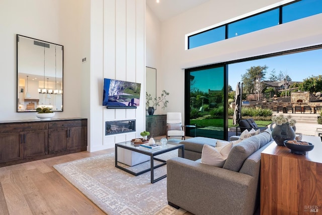 3878 Horizon View Way, Santa Rosa, CA 95404 - living room with a high ceiling, wood finished floors, and a large fireplace