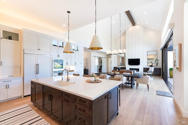3878 Horizon View Way, Santa Rosa, CA 95404 - kitchen with paneled fridge, a sink, high vaulted ceiling, dark brown cabinetry, and beam ceiling