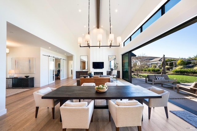 3878 Horizon View Way, Santa Rosa, CA 95404 - dining space featuring a barn door, wood finished floors, beamed ceiling, high vaulted ceiling, and a chandelier