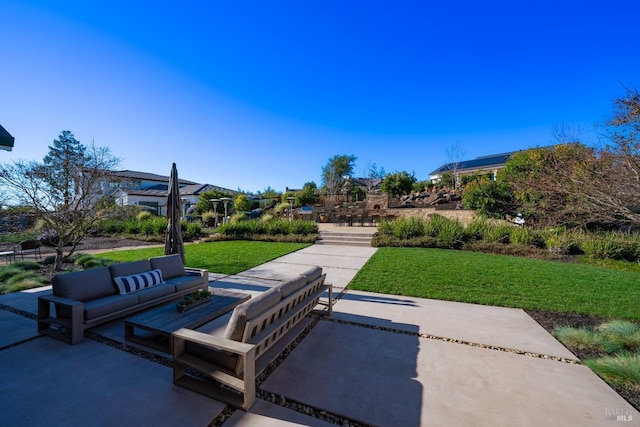 exterior space with outdoor lounge area, a lawn, and a patio area