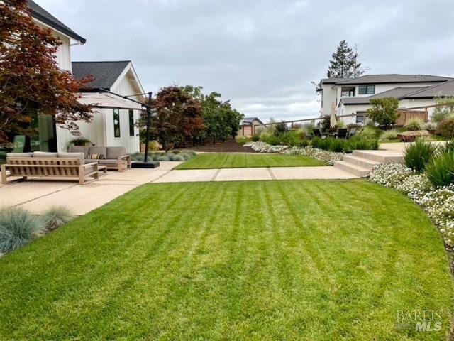 view of yard with a patio and outdoor lounge area