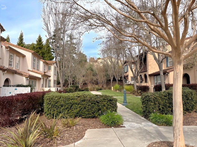 view of community with a lawn and a residential view