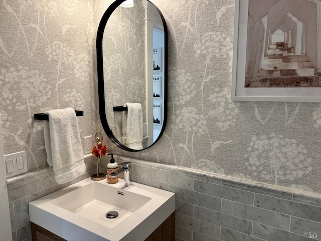 bathroom featuring tile walls and vanity