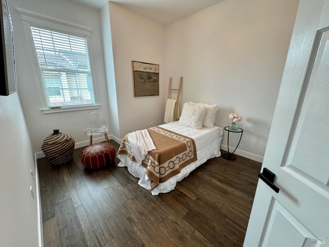 bedroom featuring dark wood-type flooring and baseboards