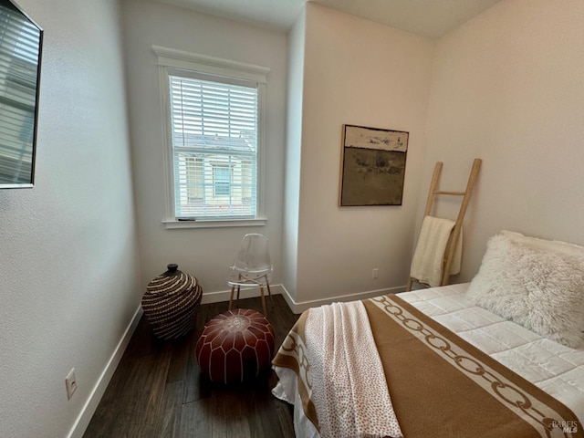 bedroom featuring dark wood finished floors and baseboards