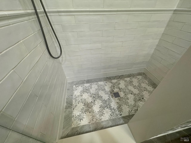 full bath featuring a tile shower