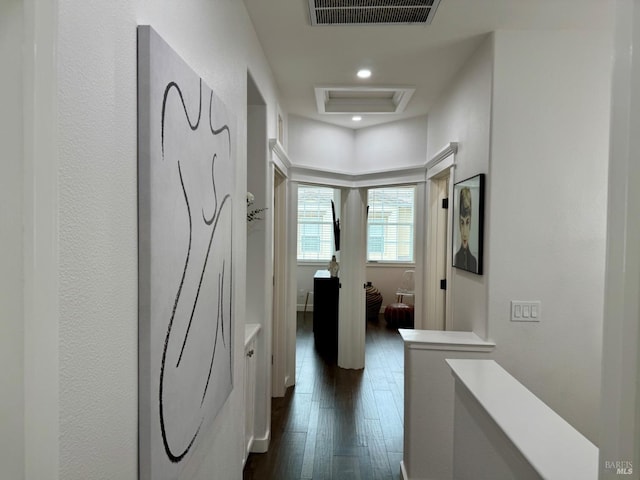 corridor with attic access, visible vents, dark wood-style flooring, an upstairs landing, and recessed lighting