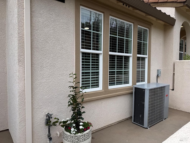 exterior space featuring central AC and stucco siding