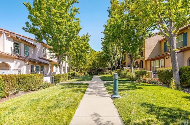 surrounding community with a residential view and a lawn