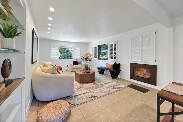 living area featuring tile patterned floors, a fireplace, and recessed lighting