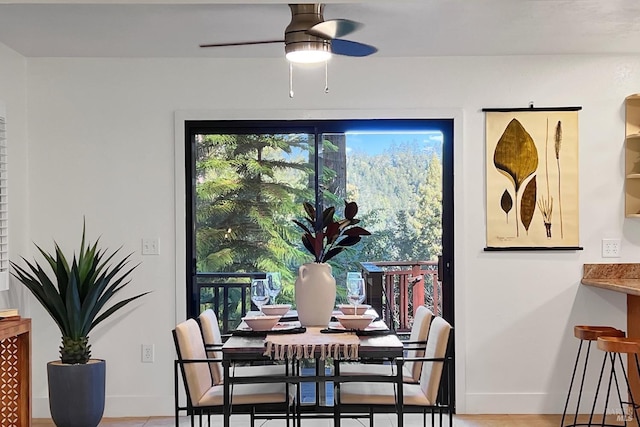 dining space with ceiling fan, a wealth of natural light, and baseboards