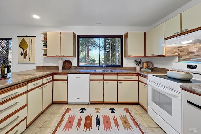 kitchen with under cabinet range hood, white appliances, a sink, decorative backsplash, and open shelves