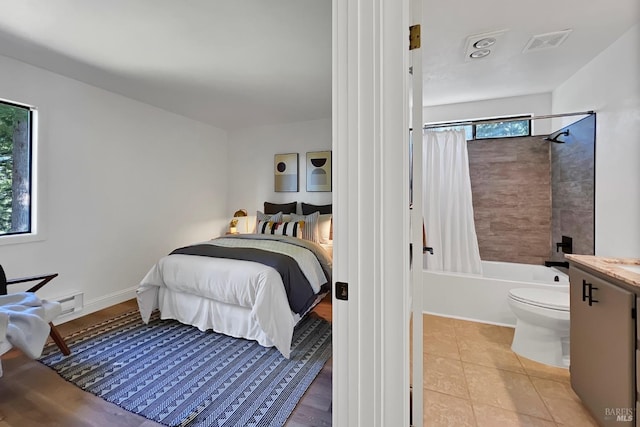 bedroom with light tile patterned flooring, visible vents, and baseboards