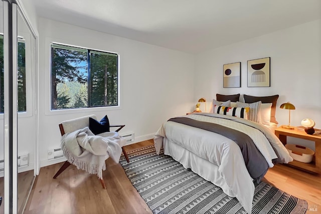 bedroom featuring baseboards and wood finished floors