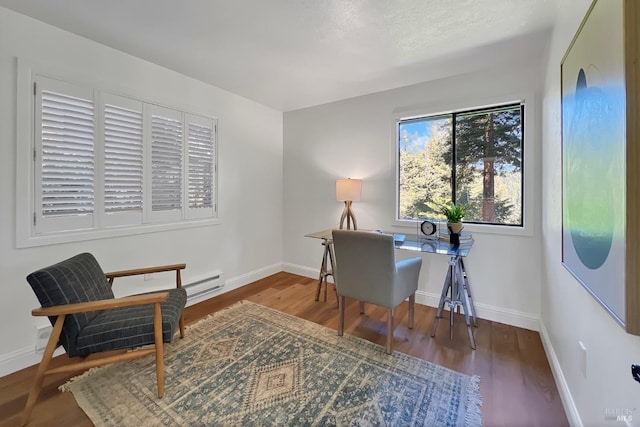 office featuring baseboards and wood finished floors