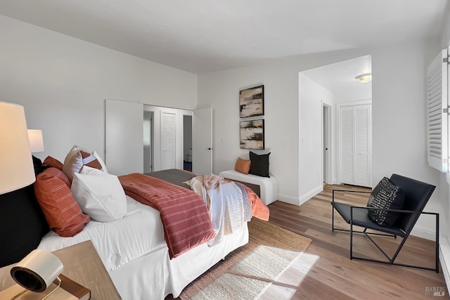 bedroom with light wood-style floors and baseboards