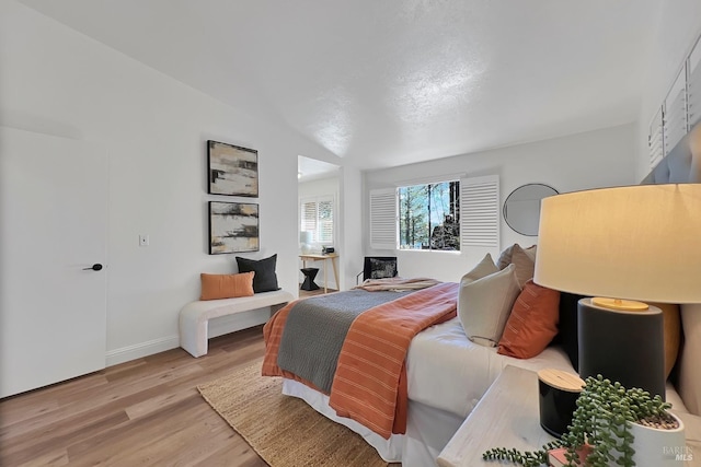 bedroom with wood finished floors and baseboards