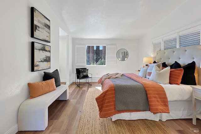 bedroom featuring wood finished floors and baseboards