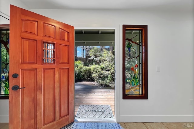 tiled foyer entrance featuring baseboards