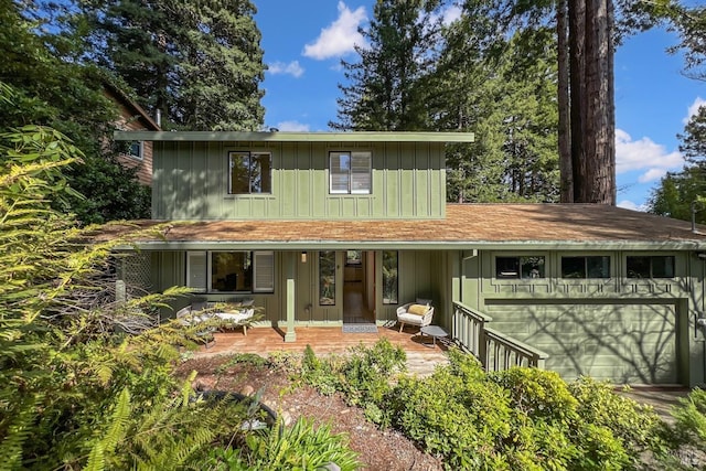 traditional-style house with a garage and board and batten siding