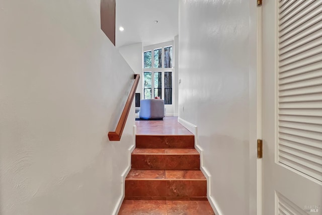 staircase featuring recessed lighting and baseboards