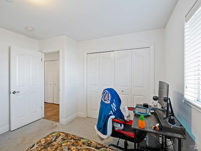 carpeted home office with baseboards