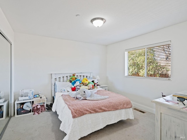 bedroom with carpet floors, a closet, visible vents, and baseboards