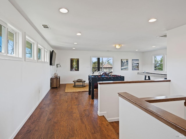 corridor with dark wood-style floors, baseboards, visible vents, and recessed lighting