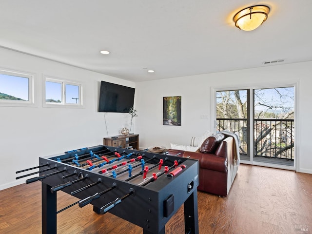 recreation room featuring recessed lighting, visible vents, baseboards, and wood finished floors