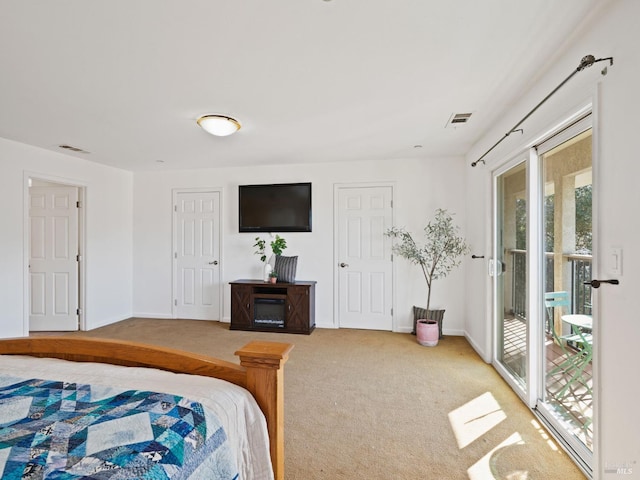 bedroom with access to outside, carpet floors, visible vents, and baseboards