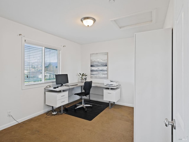 home office with dark colored carpet, attic access, and baseboards