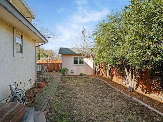 view of yard with an outdoor structure and a fenced backyard