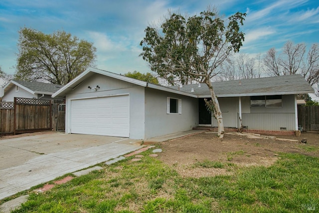 ranch-style home with an attached garage, crawl space, driveway, and fence