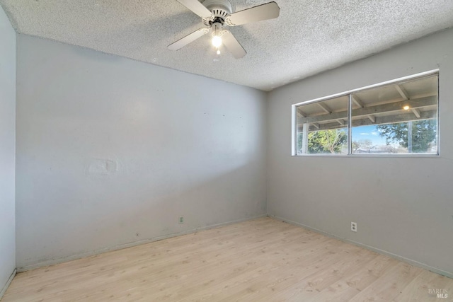 empty room featuring a textured ceiling, a ceiling fan, and wood finished floors