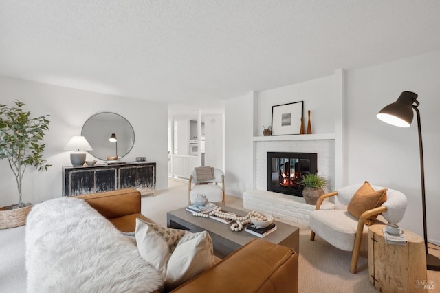 living room with a textured ceiling, a fireplace, and carpet flooring