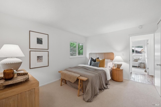 bedroom featuring carpet floors and baseboards