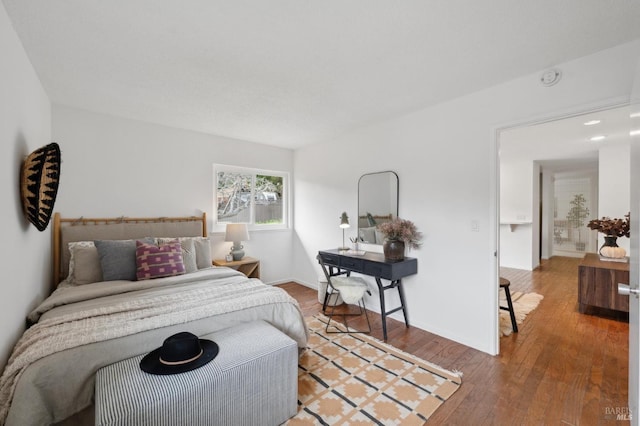 bedroom featuring wood-type flooring and baseboards