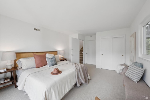 bedroom featuring a closet, carpet, and visible vents