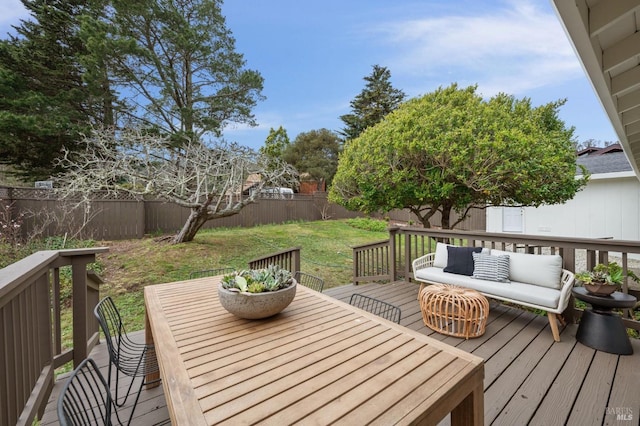 wooden deck featuring outdoor dining space, a fenced backyard, an outdoor living space, and a yard