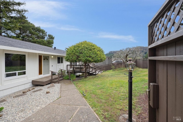 view of yard with fence and a deck