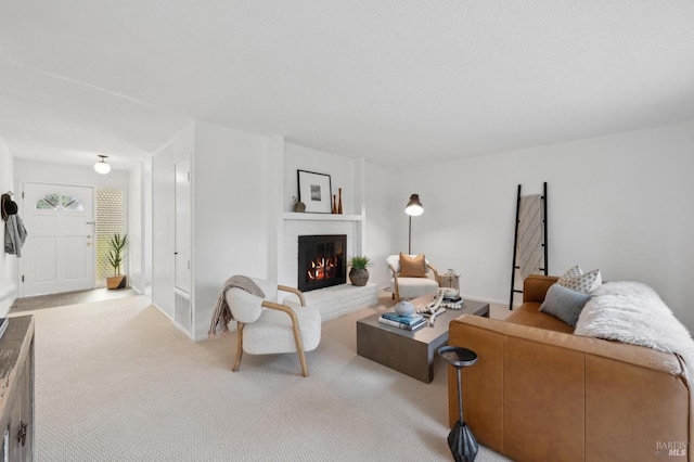 living room with carpet floors, a brick fireplace, and baseboards