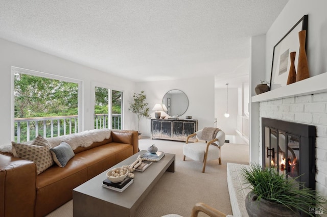 living area featuring carpet floors, a brick fireplace, and a textured ceiling