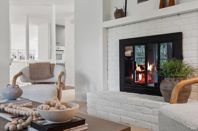 interior space featuring a brick fireplace and baseboards