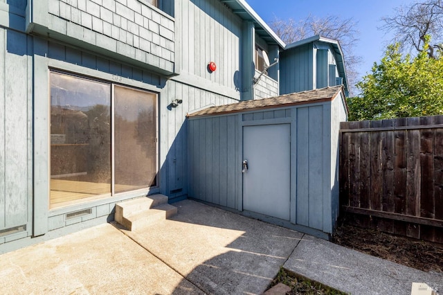 view of shed featuring fence