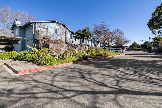 view of road featuring curbs and a residential view