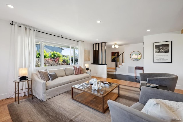 living room featuring recessed lighting, stairway, baseboards, and wood finished floors