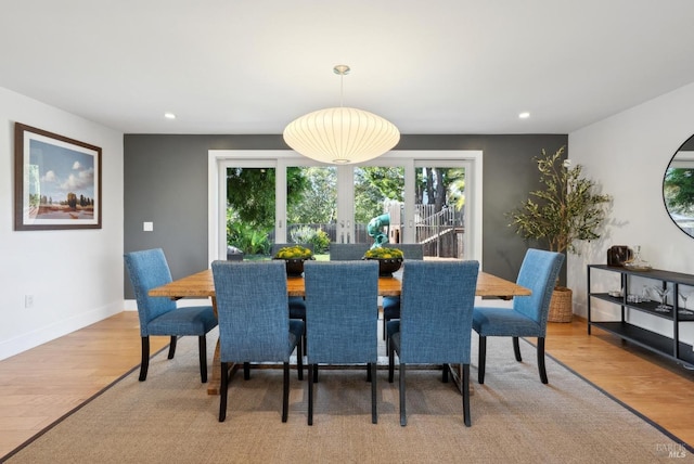 dining space with light wood-type flooring, baseboards, and recessed lighting