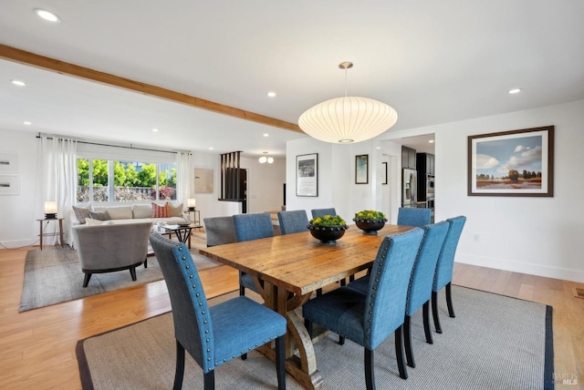 dining area featuring light wood finished floors, beamed ceiling, recessed lighting, and baseboards