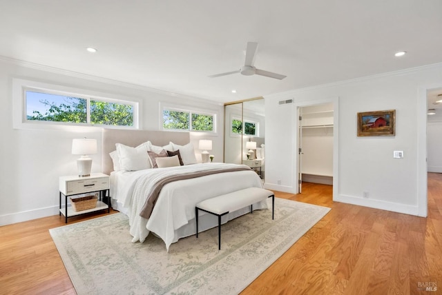 bedroom with visible vents, baseboards, light wood-style flooring, ornamental molding, and recessed lighting