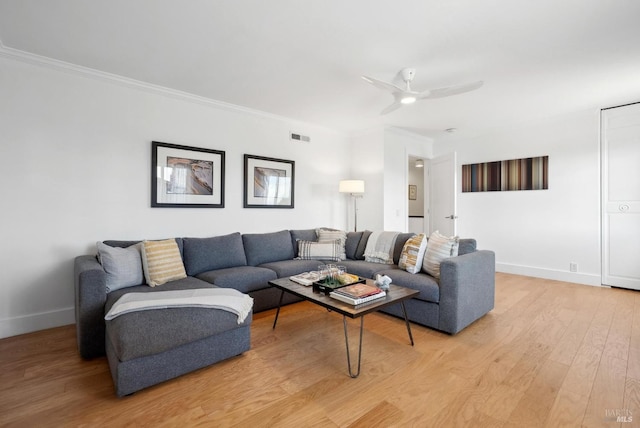 living area with a ceiling fan, visible vents, baseboards, ornamental molding, and light wood finished floors